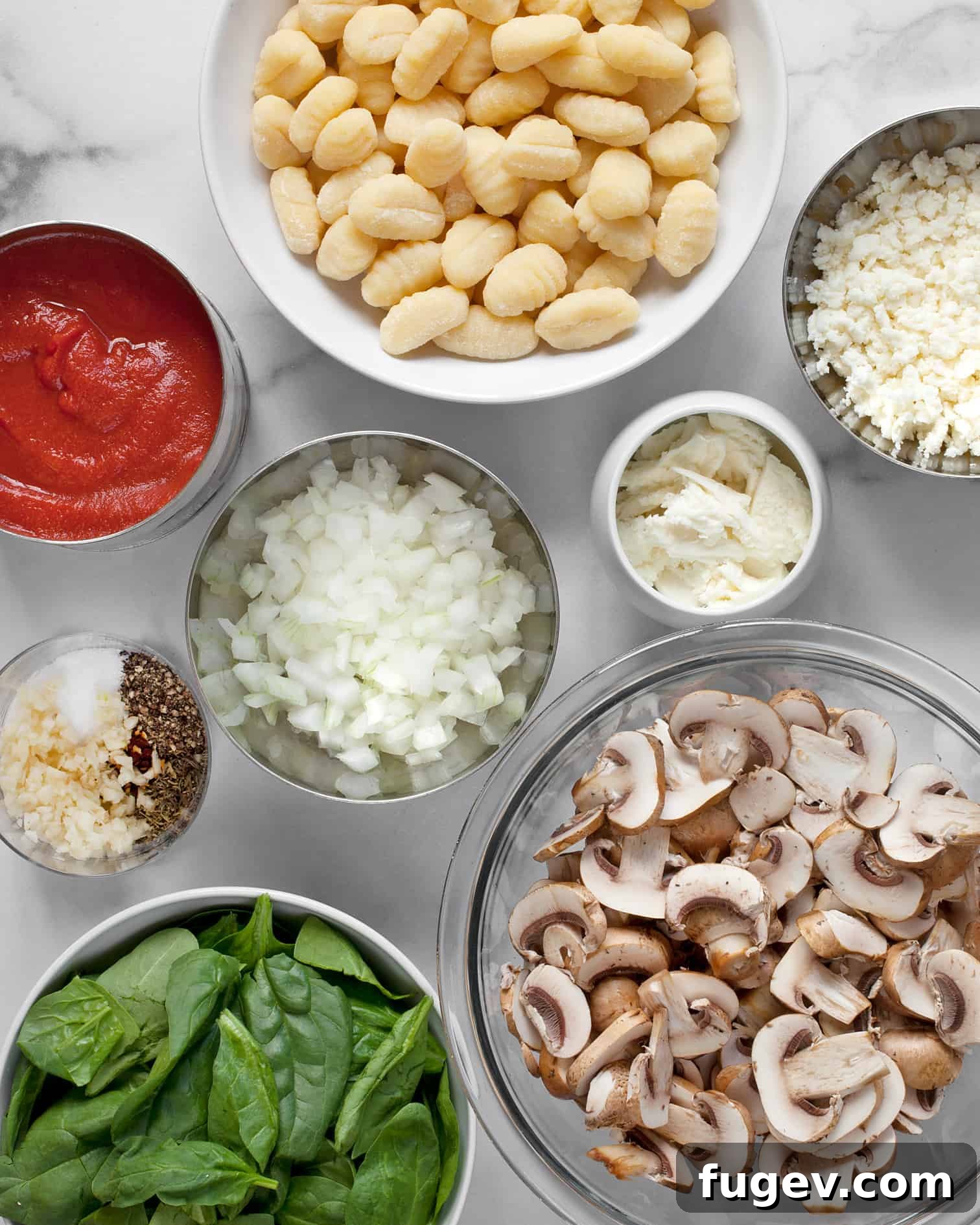 Hearty Mushroom & Spinach Gnocchi Bake 3 Store-bought gnocchi, sliced cremini mushrooms, fresh spinach, and other ingredients laid out for baked gnocchi recipe