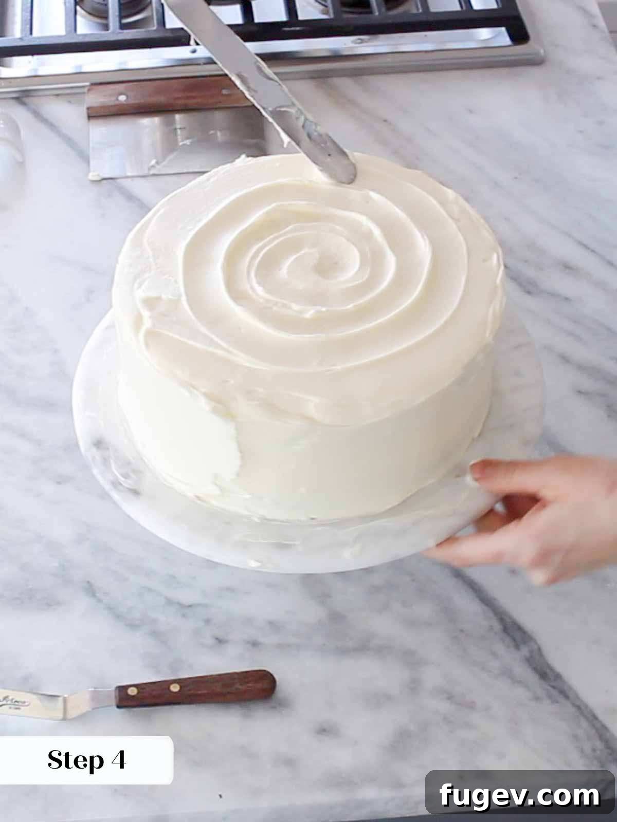 Sweet Nectar Delight 14 swirling buttercream on top of hummingbird cake.