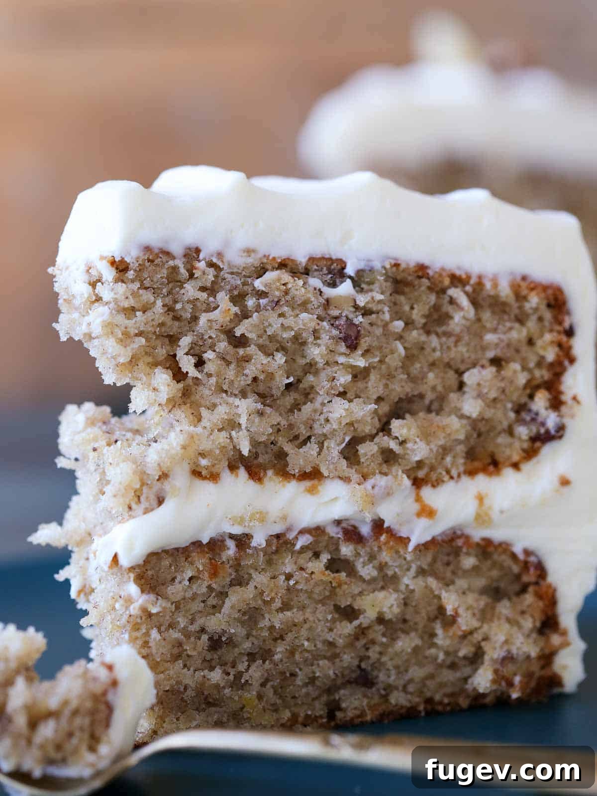 Sweet Nectar Delight 16 moist tender hummingbird cake on plate with gold fork.