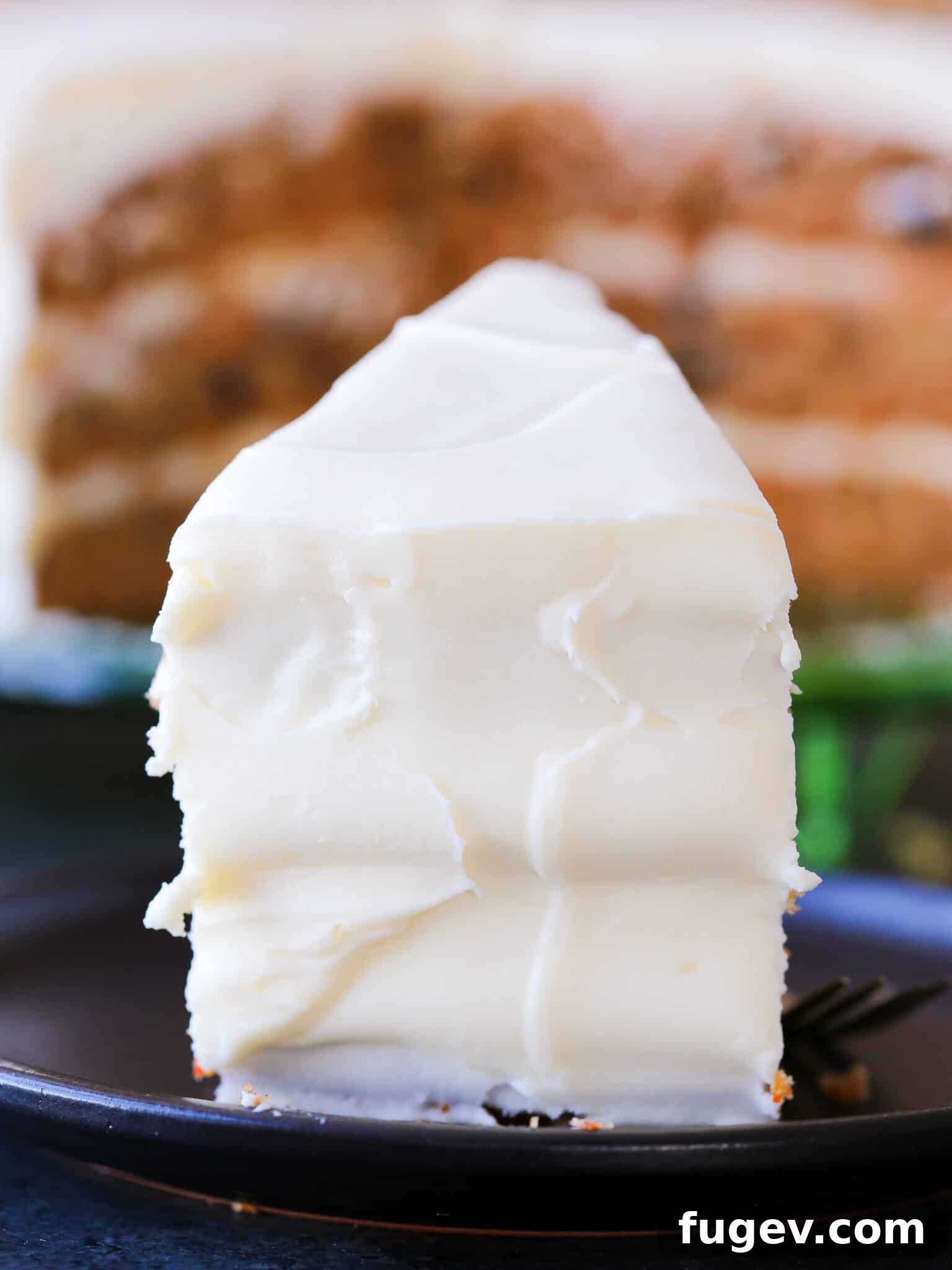 Foolproof Carrot Cake Recipe 5 A beautifully frosted slice of carrot cake with cream cheese frosting, smooth and inviting.