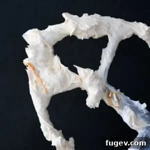 A close-up of a perfectly piped Caramel Swiss Meringue Buttercream swirl.