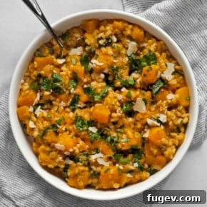 Baked butternut squash risotto with barley and kale in a bowl.