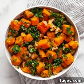 Sautéed butternut squash with kale in a bowl, ready to serve.