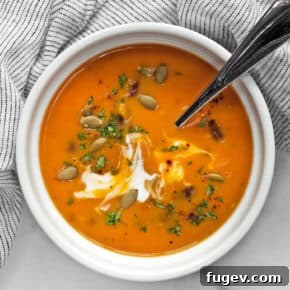 Spicy Chipotle Butternut Squash Soup in a bowl with a spoon.