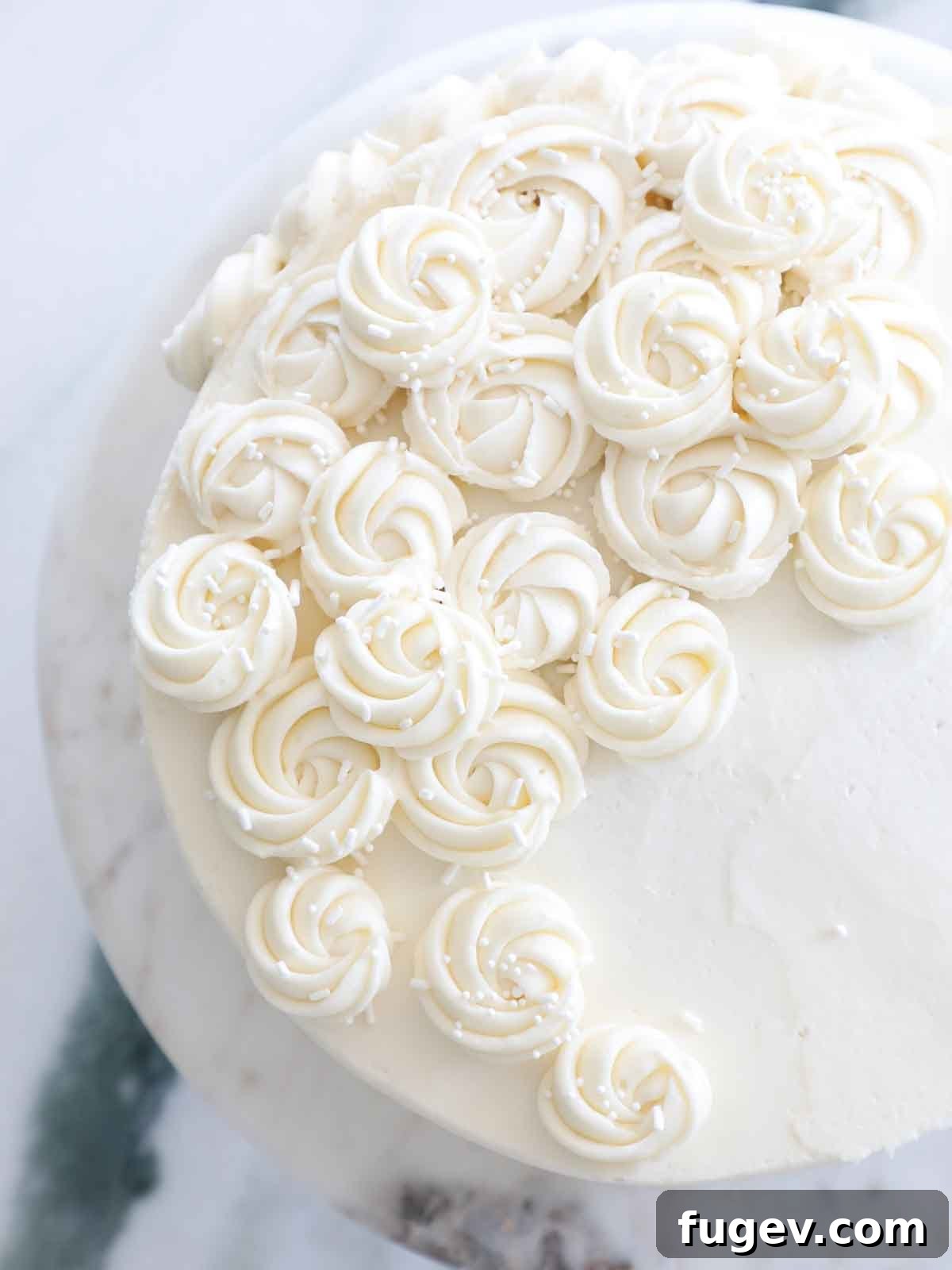 The Ultimate American Buttercream Recipe 2 Vanilla American buttercream piped into elegant rosettes on a cake, showcasing its perfect texture.
