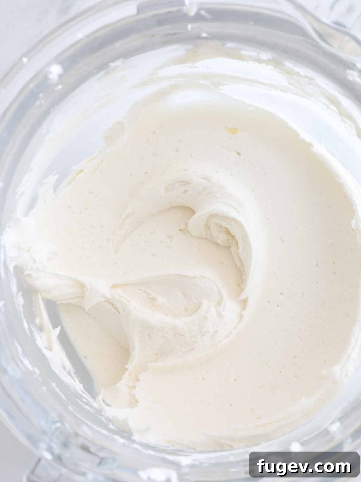 The Ultimate American Buttercream Recipe 3 Perfectly smooth and fluffy vanilla American buttercream in a stand mixer bowl, ready for frosting.