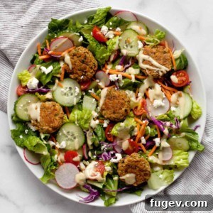 Baked falafel salad on a plate, close-up.
