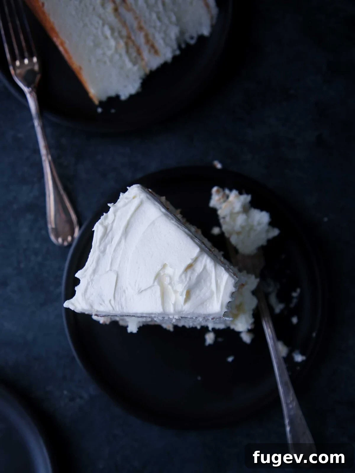 Elegant White Layer Cake 4 A beautifully frosted slice of classic white cake, showcasing its moist texture.