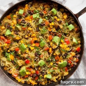 Fiesta Spaghetti Squash 7 Spaghetti squash with beans, corn and peppers in a skillet, showcasing the completed dish.