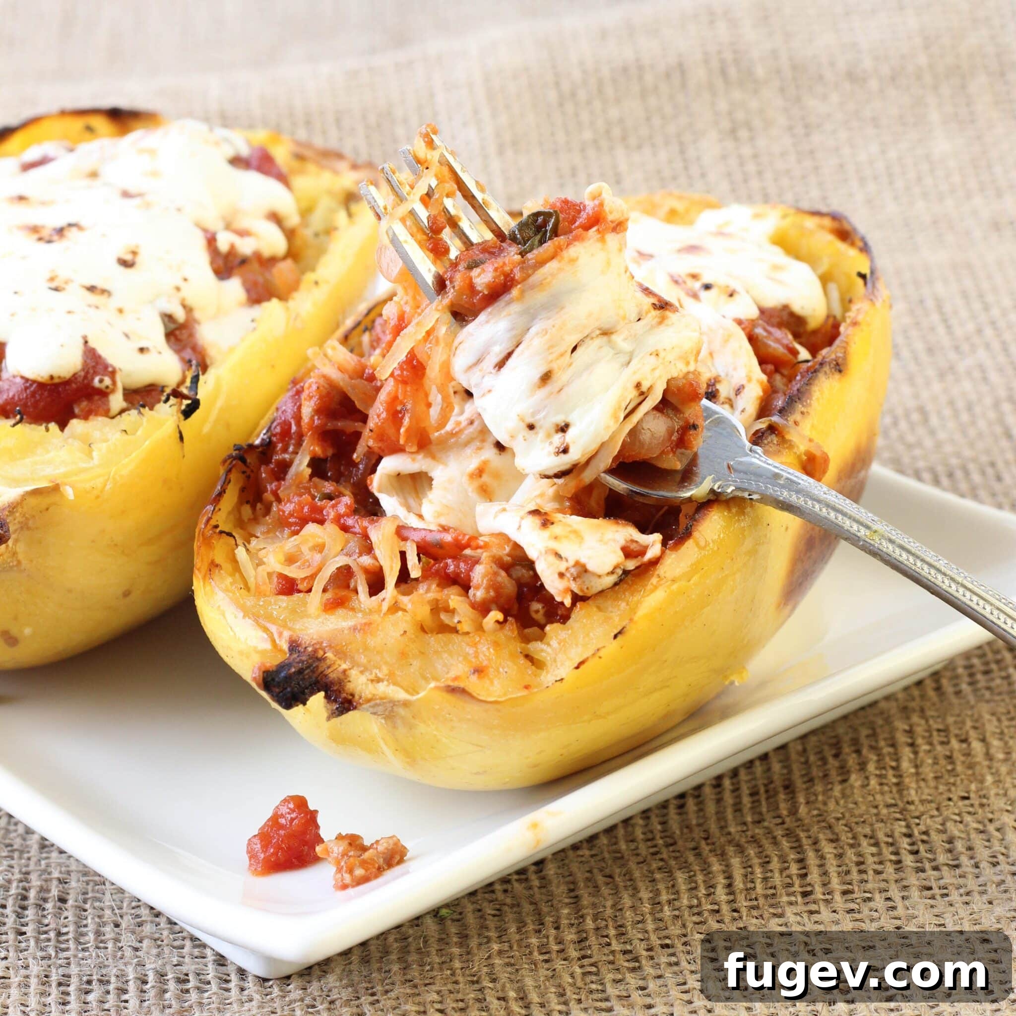 Golden Twice Baked Spaghetti Squash Bake 3 Close-up of Twice Baked Spaghetti Squash with rich turkey sauce and melted mozzarella cheese, ready to serve.