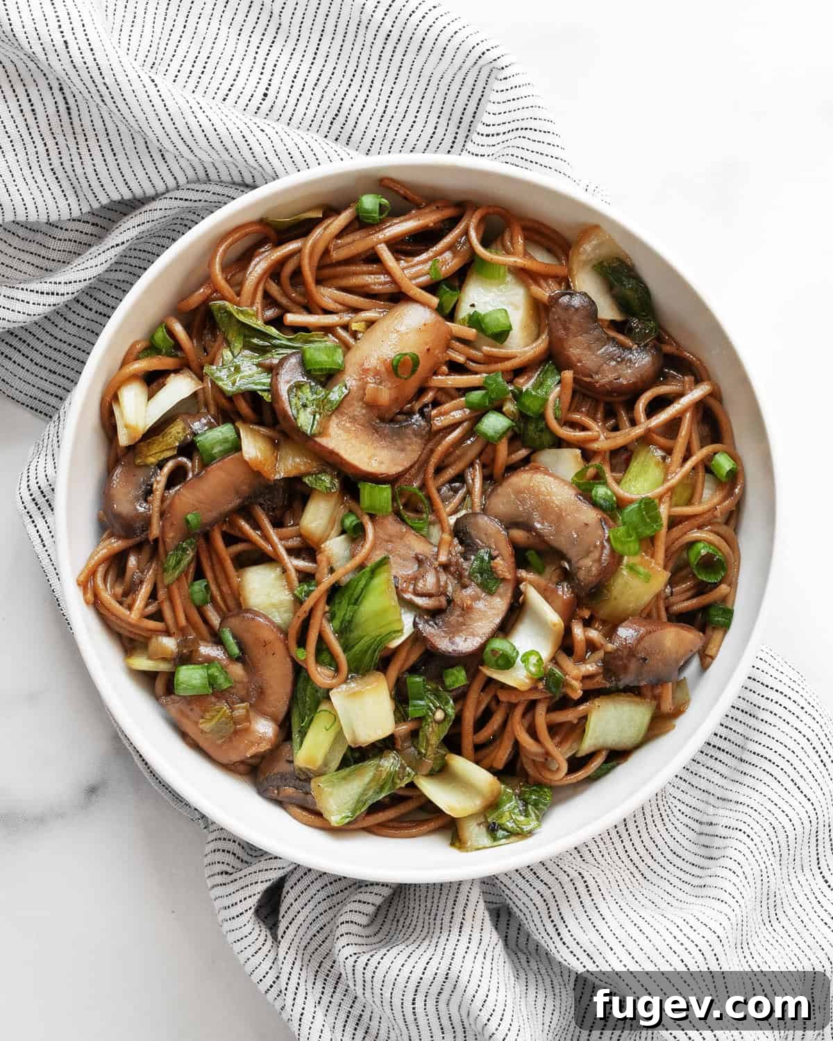 Earthy Mushroom & Crisp Bok Choy Soba Stir-Fry 7 A beautifully presented bowl of mushroom and bok choy soba noodle stir-fry, ready to be enjoyed.