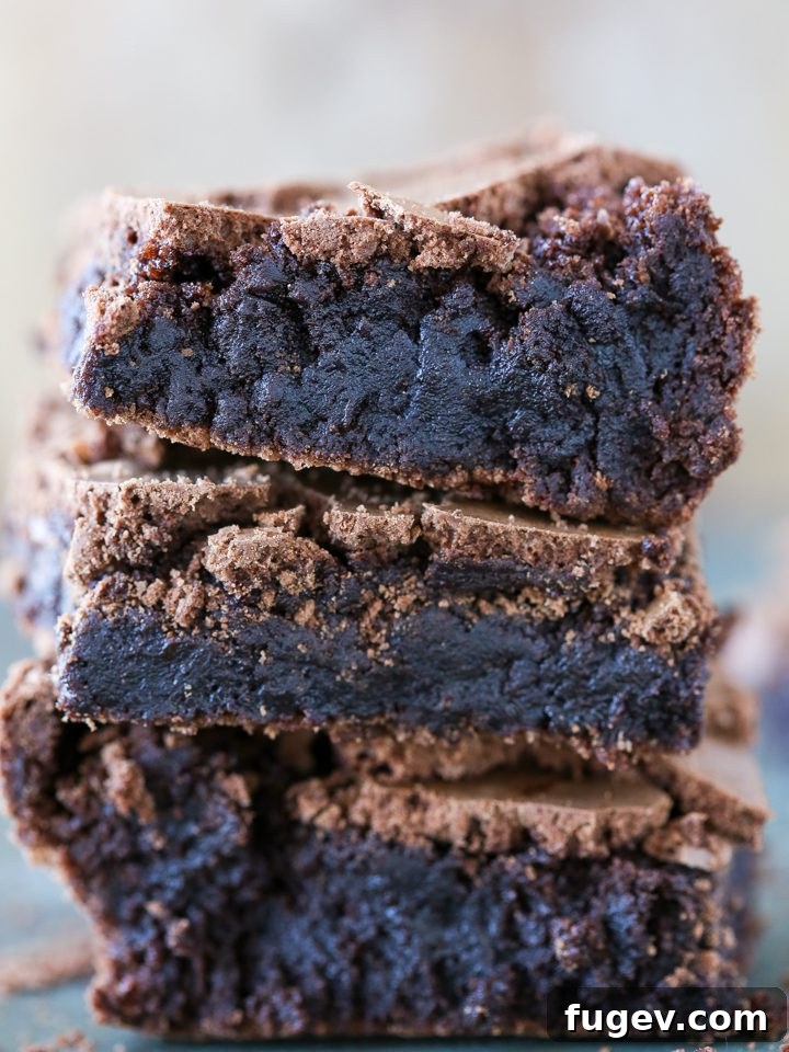 Golden Brown Butter Indulgence 2 Stacked brown butter brownies showcasing their fudgy texture and crinkly tops.