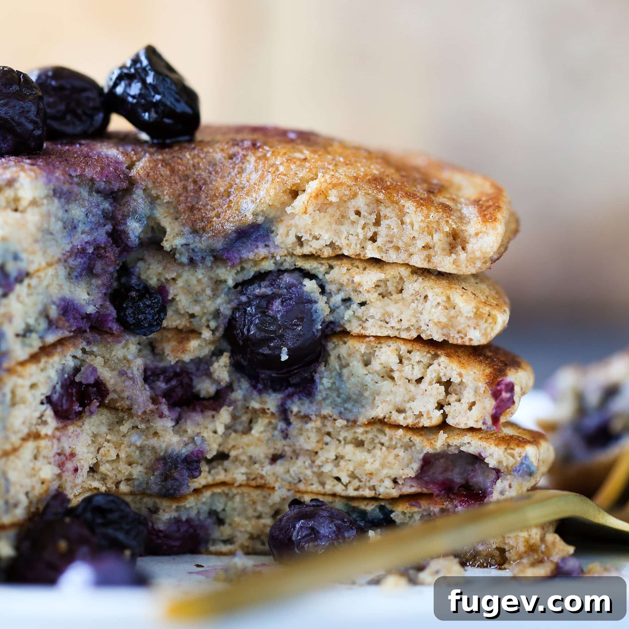 Delicious Dairy-Free Whole Wheat Pancakes 2 Whole Wheat Pancakes stacked with syrup and blueberries