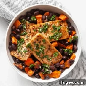 Roasted tofu, sweet potato and black beans in a bowl.