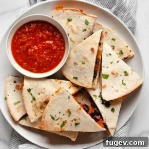 Sweet potato black bean quesadillas cut into triangles on a plate.