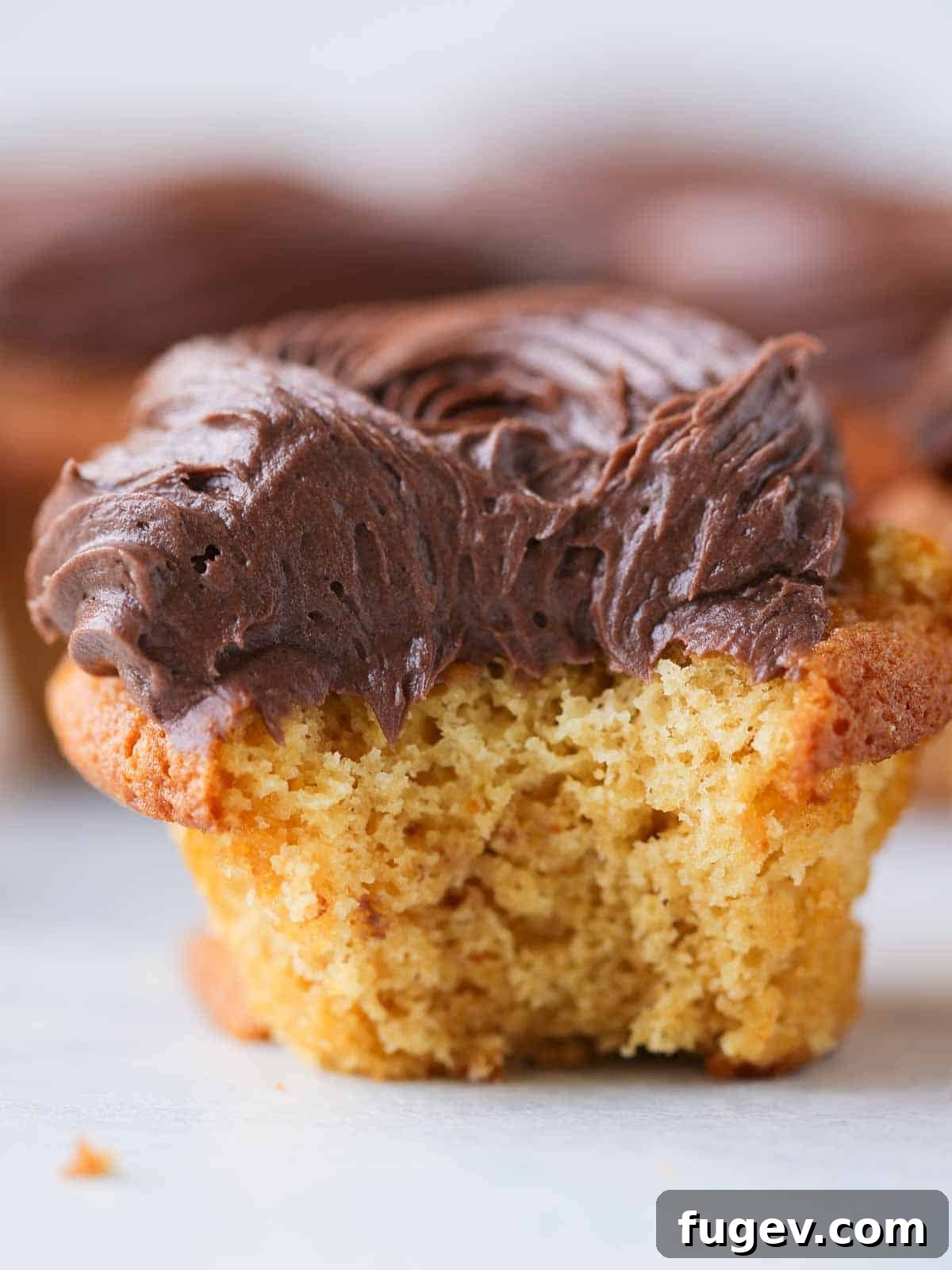 Gooey Chocolate Caramel Dreams 3 A soft, inviting caramel cupcake topped with elegant chocolate frosting, ready to be enjoyed.