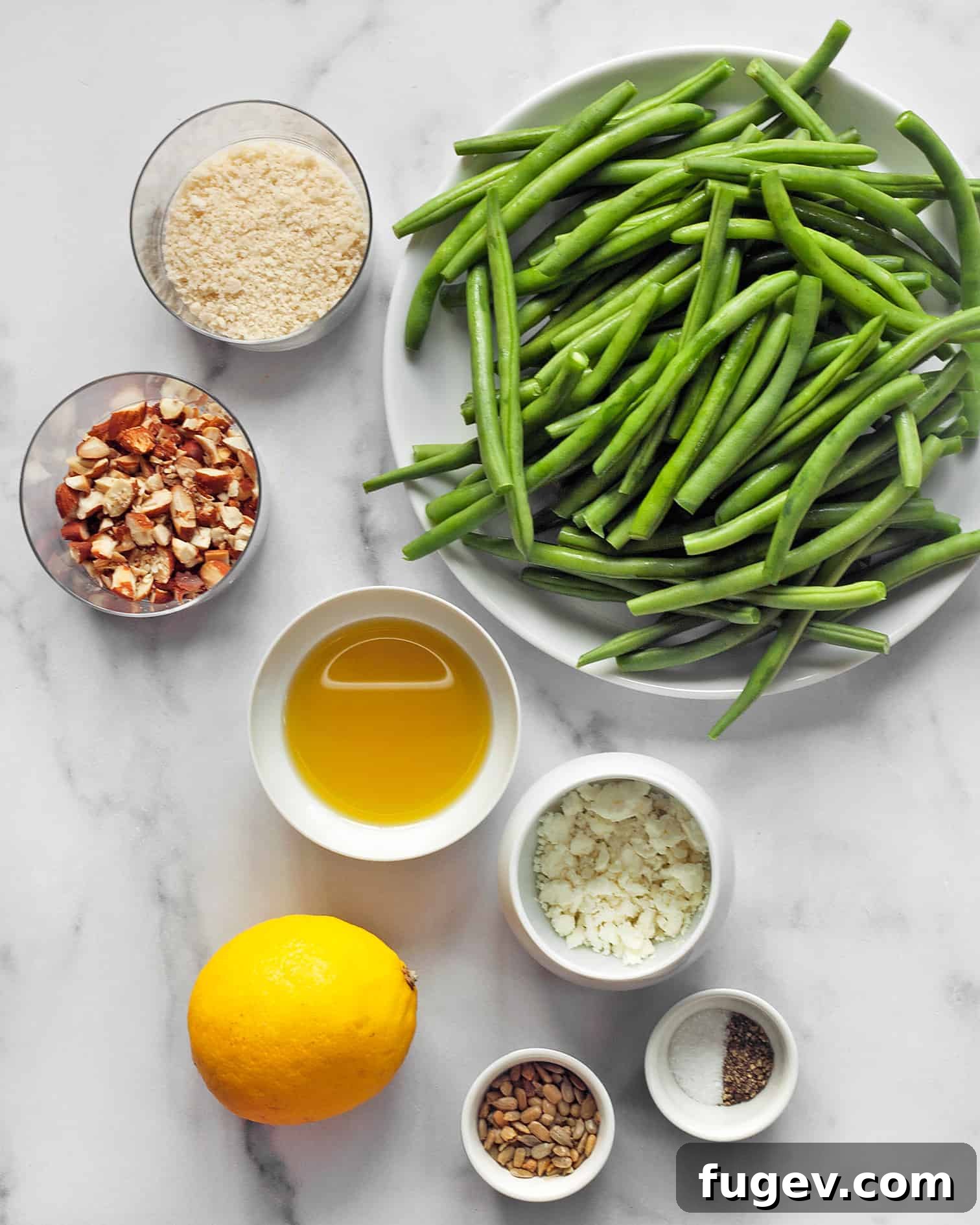 Almond Crusted Roasted Green Beans 3 A vibrant selection of fresh ingredients including crisp green beans, golden panko breadcrumbs, whole almonds, premium olive oil, bright lemons, and savory feta cheese.