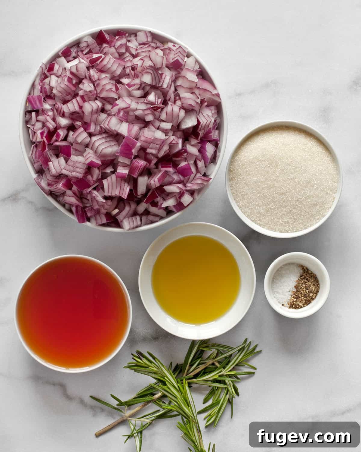 Artisan Sweet Onion Preserve 3 A flat lay showing all seven ingredients for onion jam: red onions, granulated sugar, red wine vinegar, olive oil, fresh rosemary sprigs, kosher salt, and black pepper.