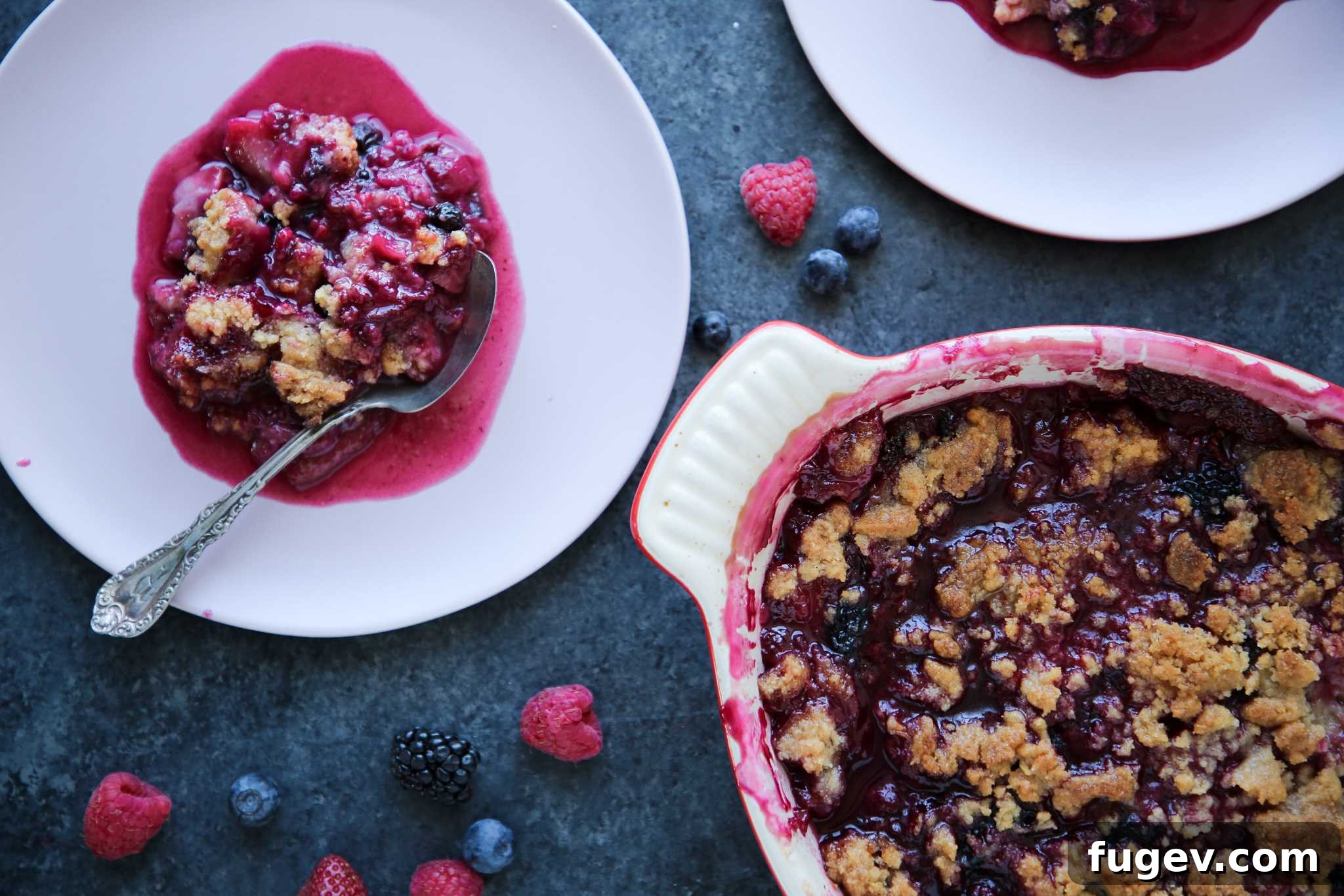 Irresistible Berry Crumble 4 Mixed berry crumble with fresh berries and mint sprigs as garnish.