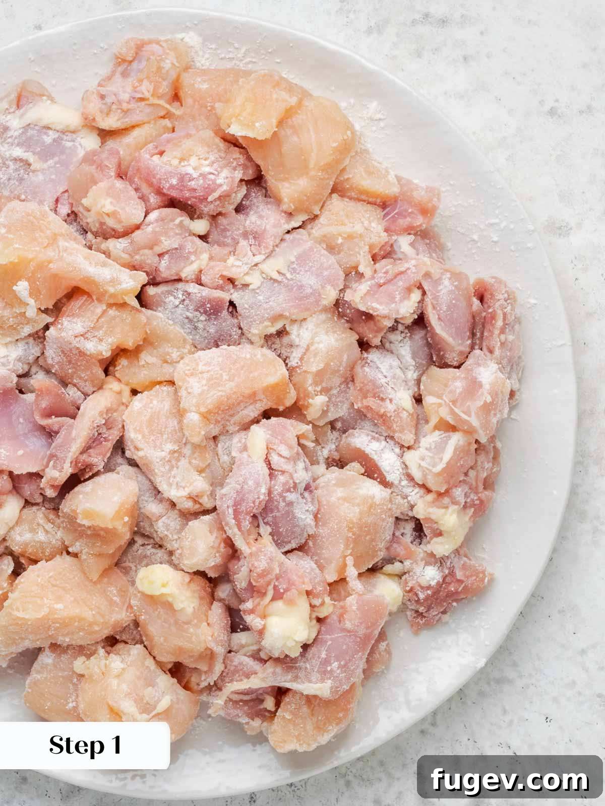 Grandma's Hungarian Chicken Paprikash 4 Diced chicken pieces lightly coated in flour, ready for cooking.