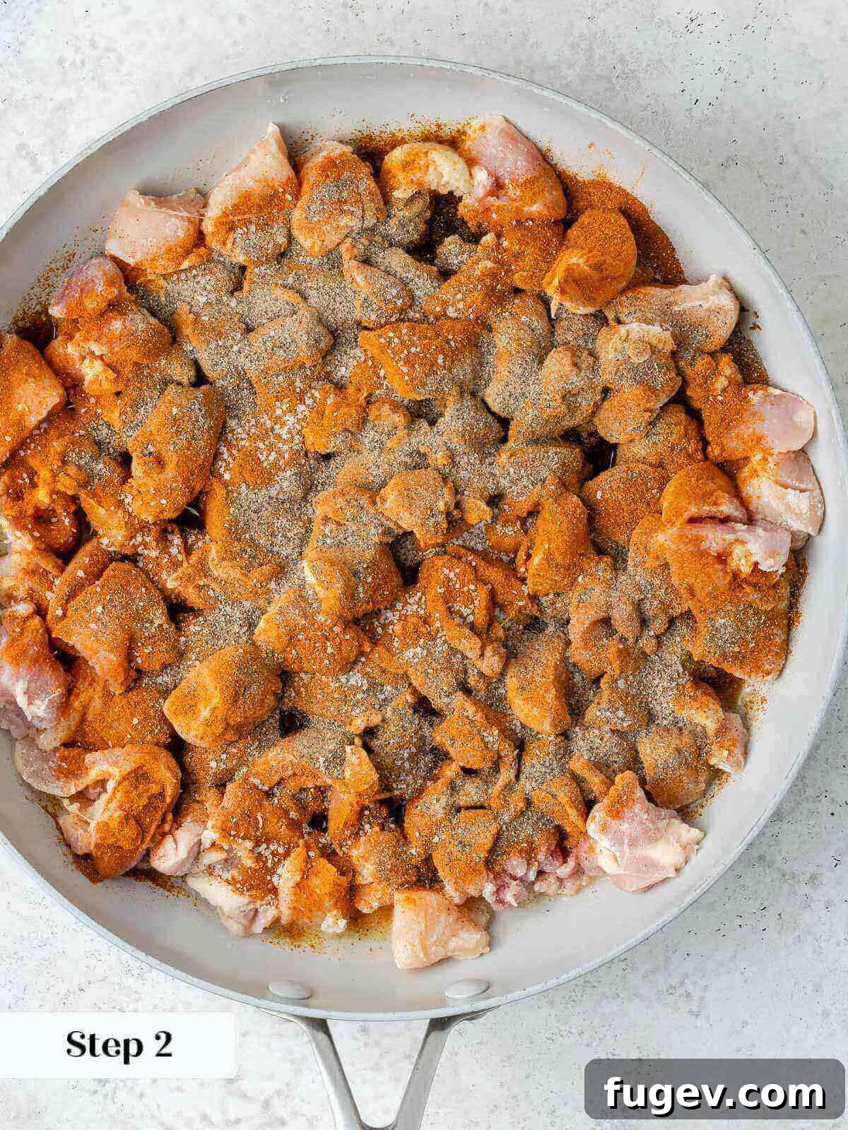 Grandma's Hungarian Chicken Paprikash 5 Chicken browning in a skillet with spices, showing a rich color.