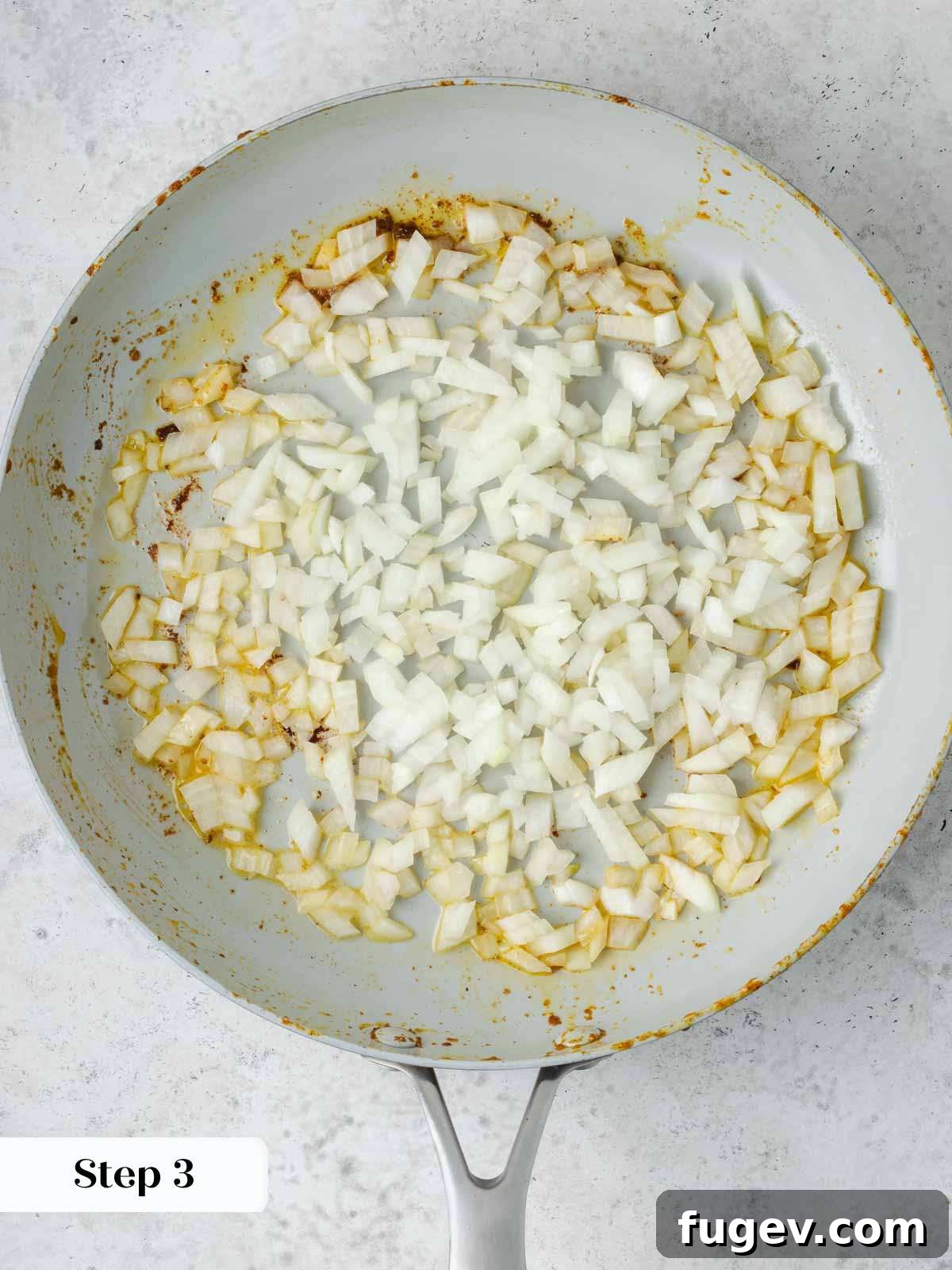 Grandma's Hungarian Chicken Paprikash 6 Chopped onions sautéing in a pan with butter, becoming translucent.
