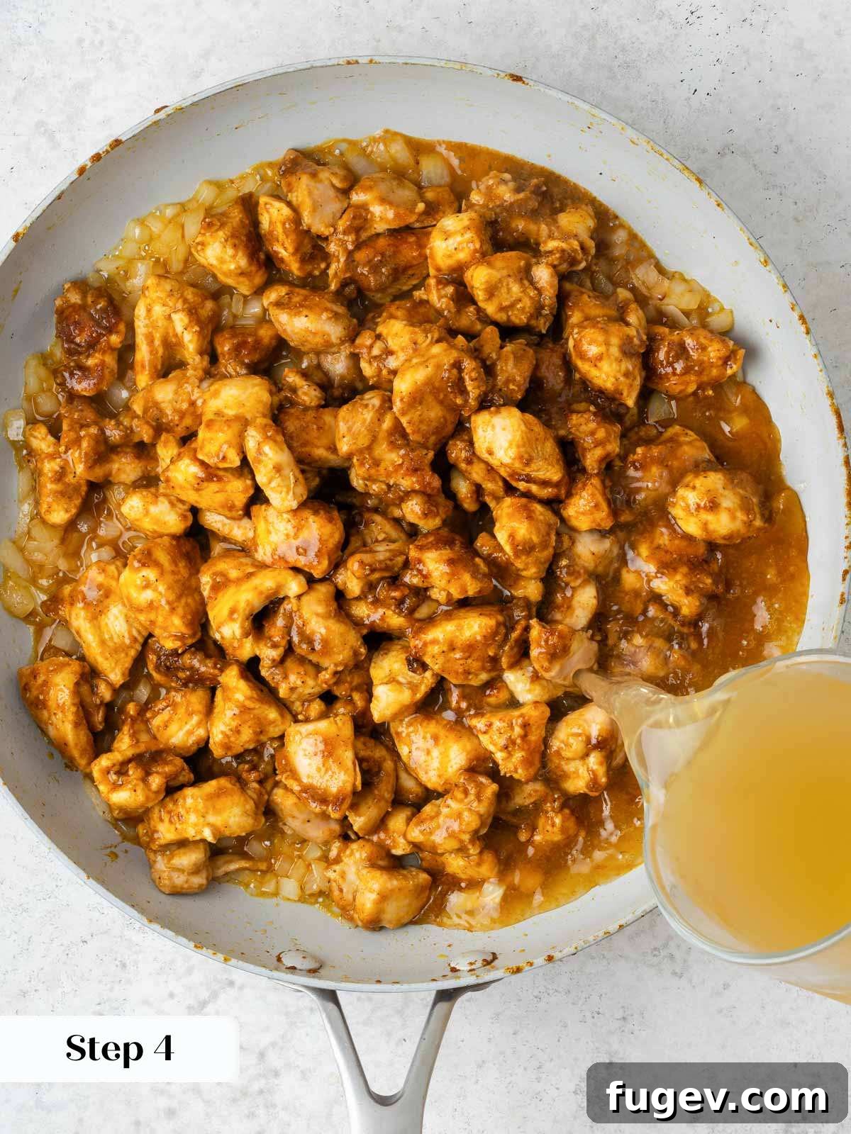 Grandma's Hungarian Chicken Paprikash 7 Chicken paprikash simmering with chicken stock, creating a rich base.