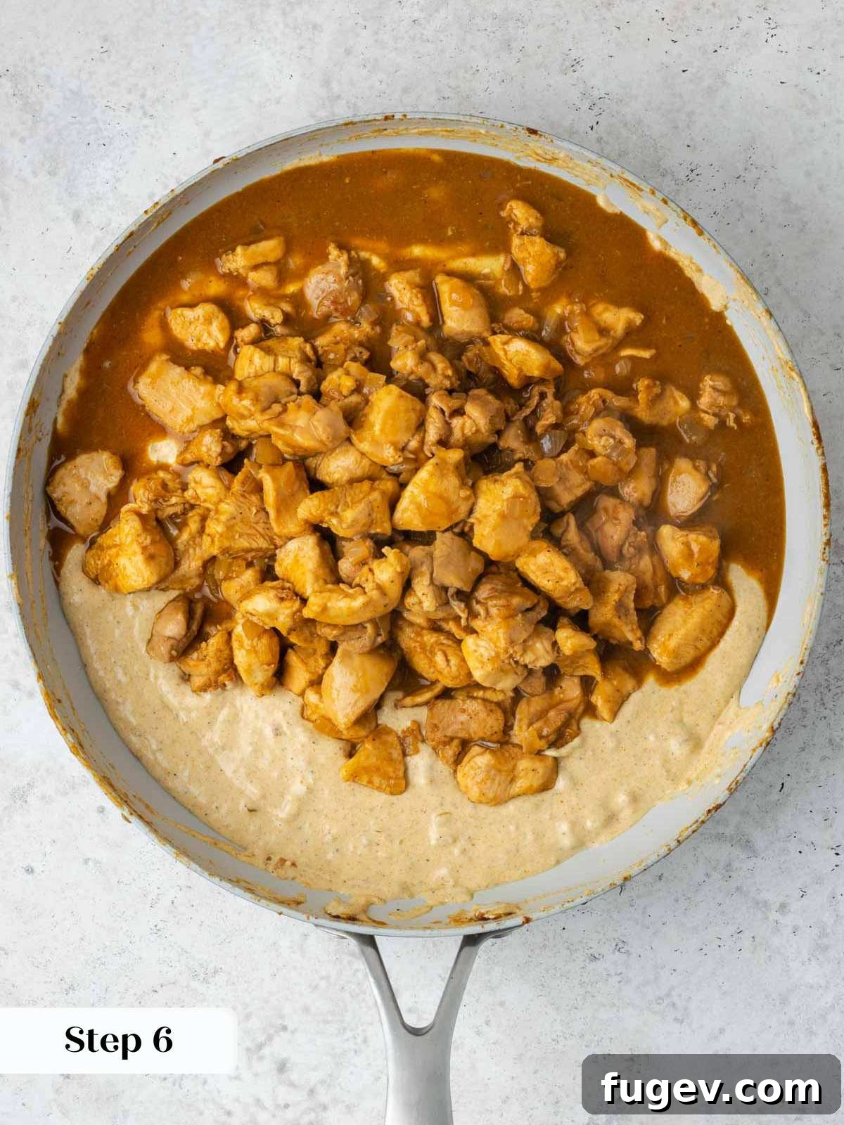 Grandma's Hungarian Chicken Paprikash 9 Thickened chicken paprikash sauce with chicken pieces in the pan, ready for serving.