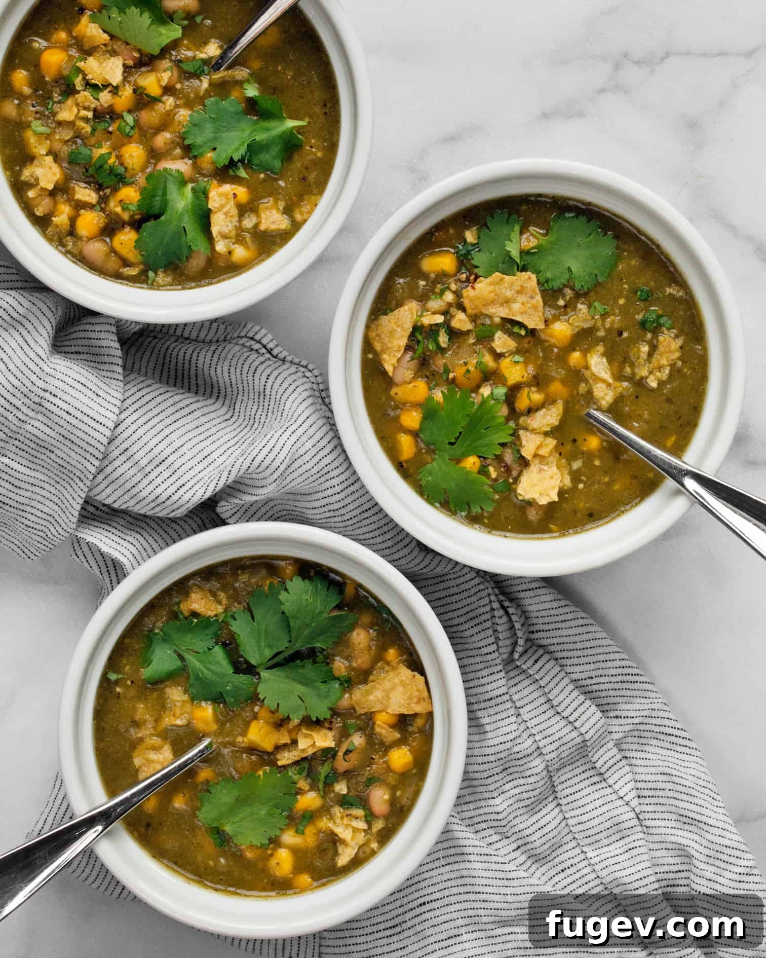 Flavorful Chile Verde with Creamy White Beans 3 Three small bowls of vegan chile verde, perfectly portioned and ready for serving, showcasing the rich green color.