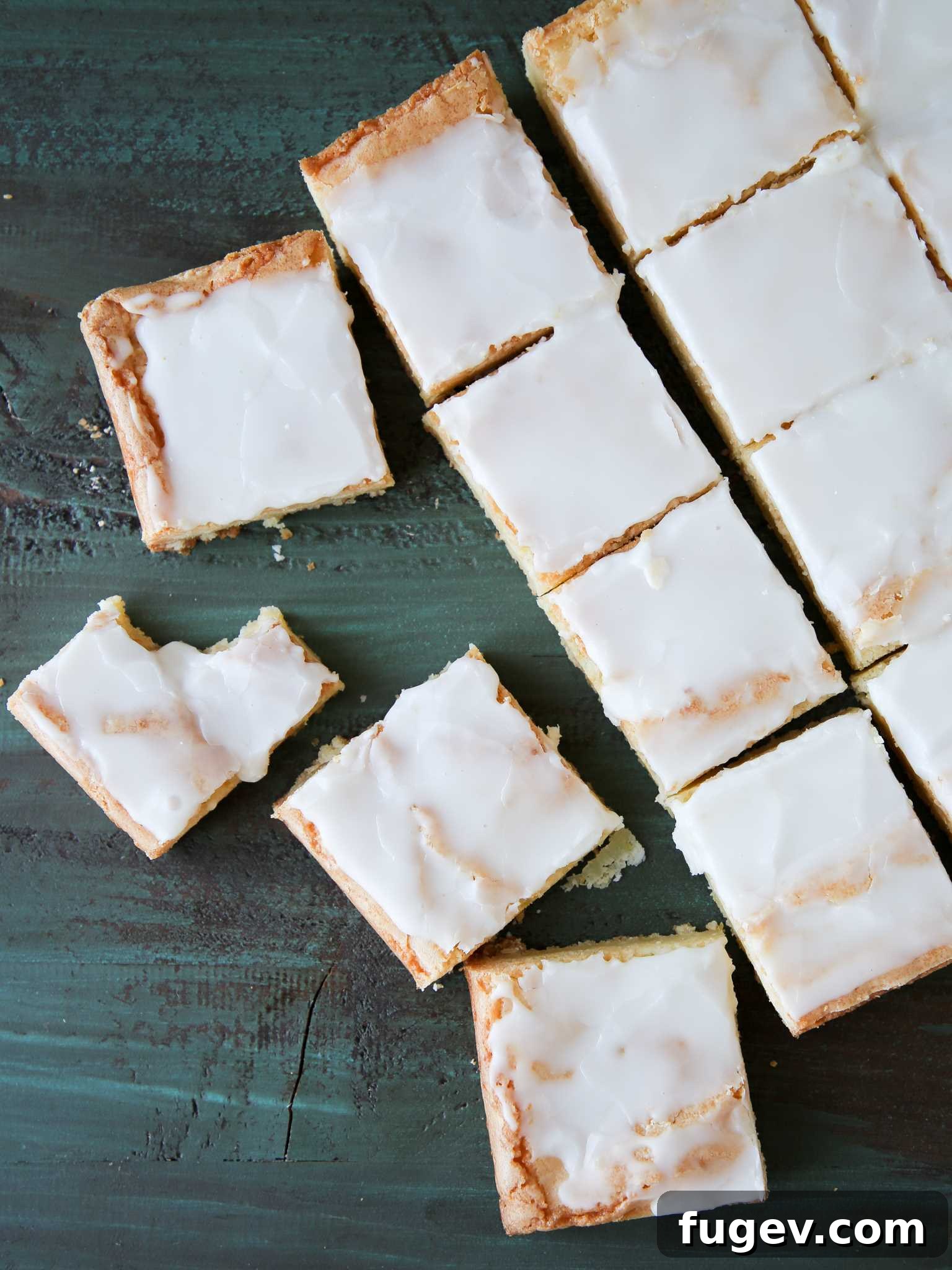 Golden Lemon Squares 5 Individual slices of Lemon Blondies arranged neatly on a platter, showcasing their vibrant color and inviting texture.