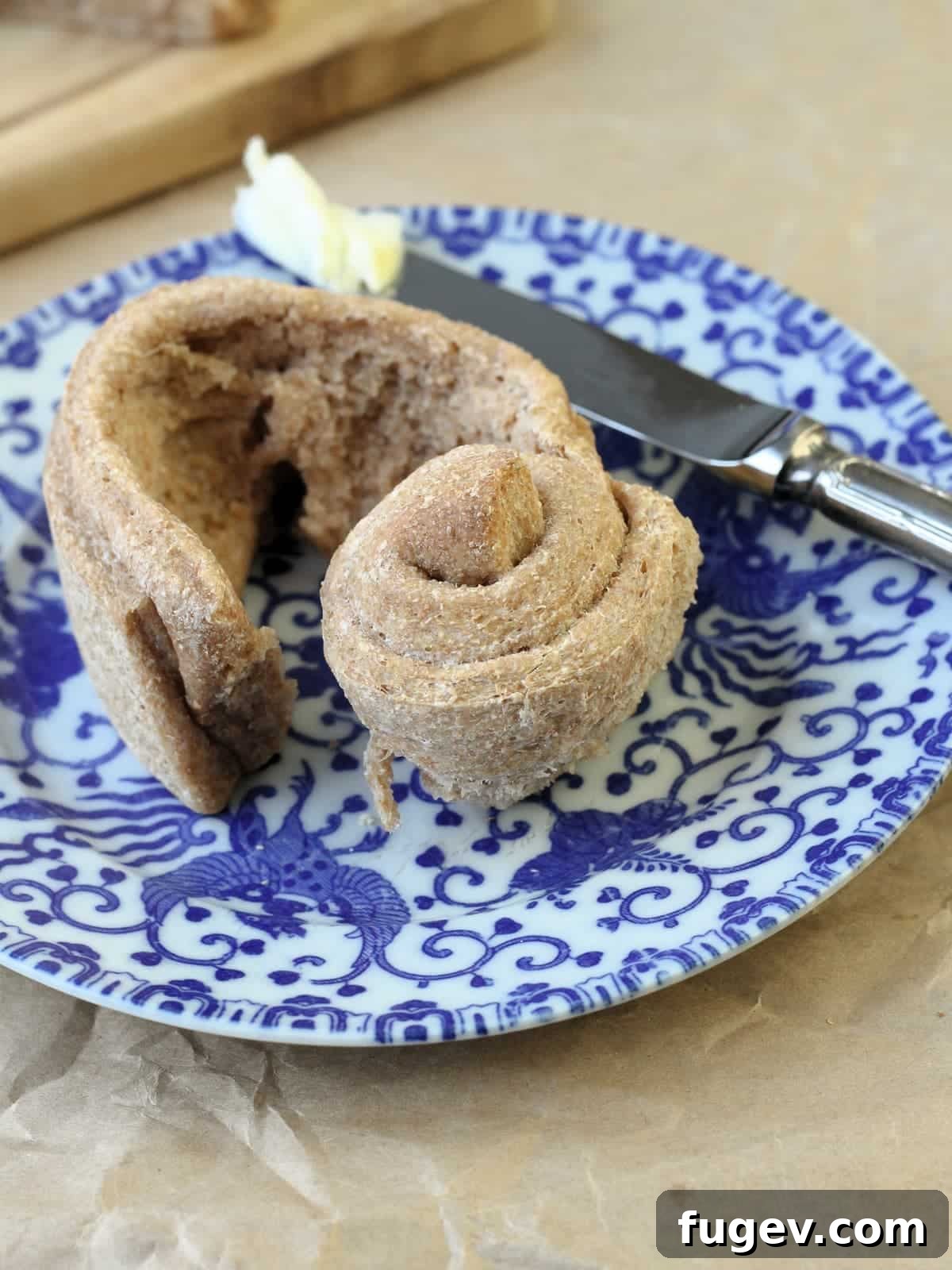 Rustic Wheat Rolls 5 A warm, freshly baked whole wheat roll, gently ripped open to reveal its visible fluffy, tender interior, steam still wafting.