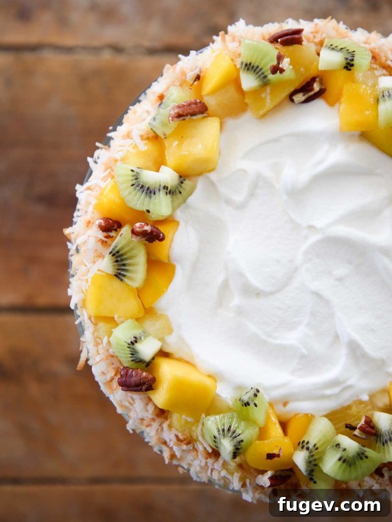 Paradise Trifle Delight 2 Tropical Trifle Recipe displayed on a rustic wood slate background, showcasing its vibrant layers