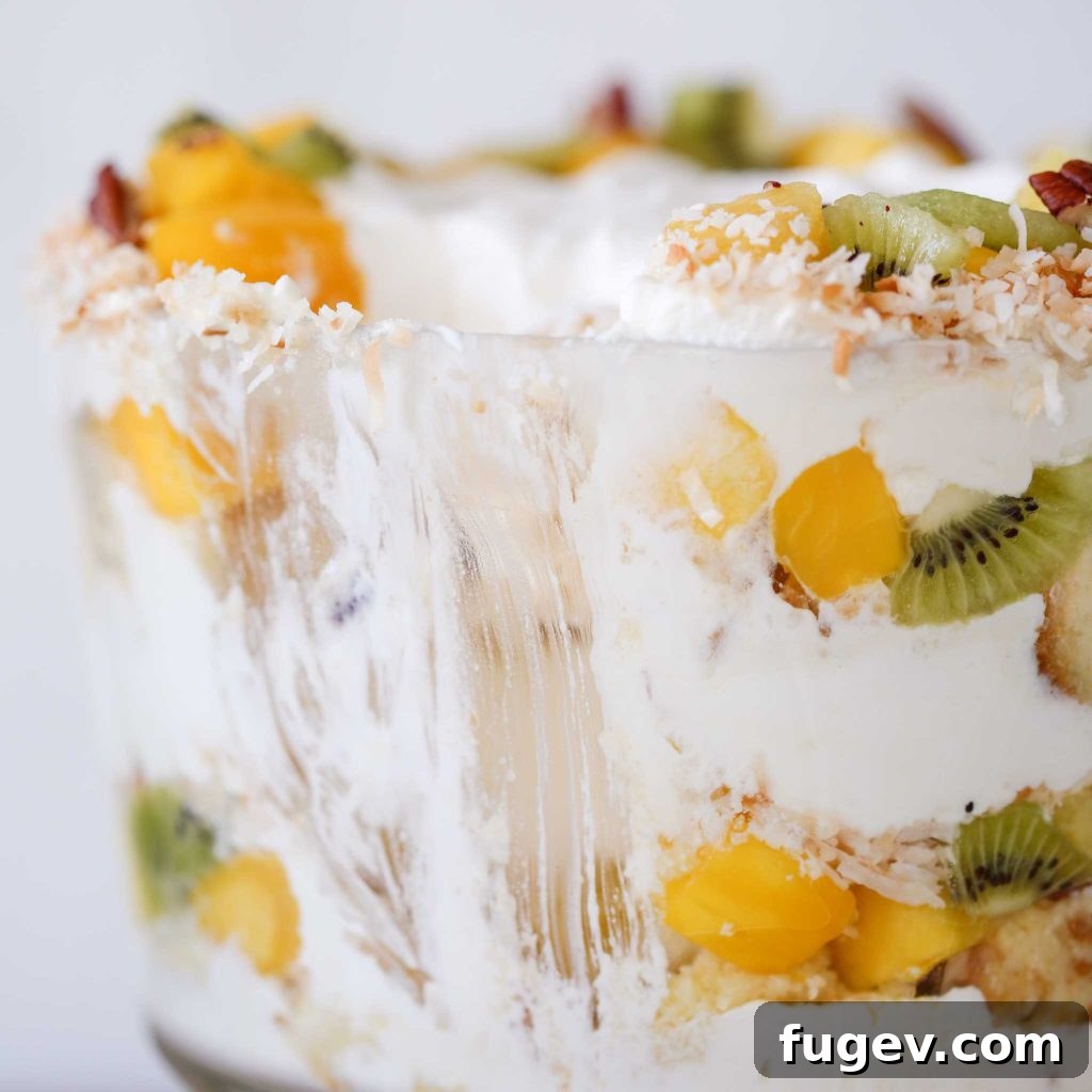 Paradise Trifle Delight 3 Close-up interior view of a Tropical Trifle, showing distinct layers of cake, fruit, and cream