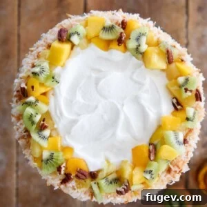 Tropical Fruit Trifle decorated with fresh fruit pecans coconut.