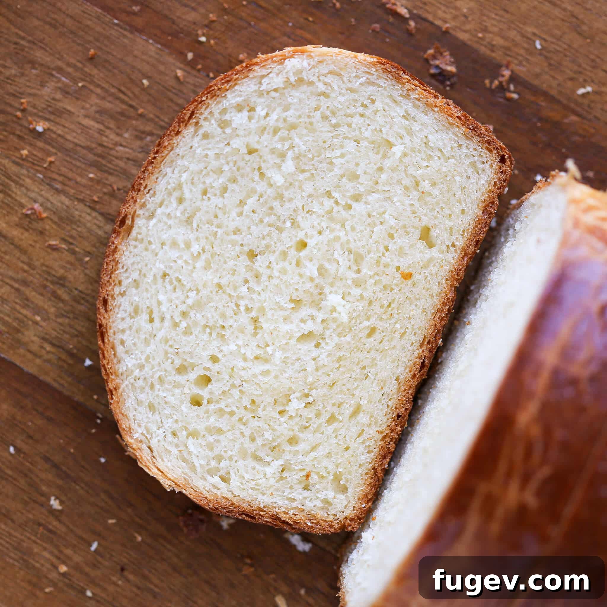 Golden Buttery Brioche Loaf 17 A slice of brioche bread resting on a rustic wooden board, ready to be enjoyed.