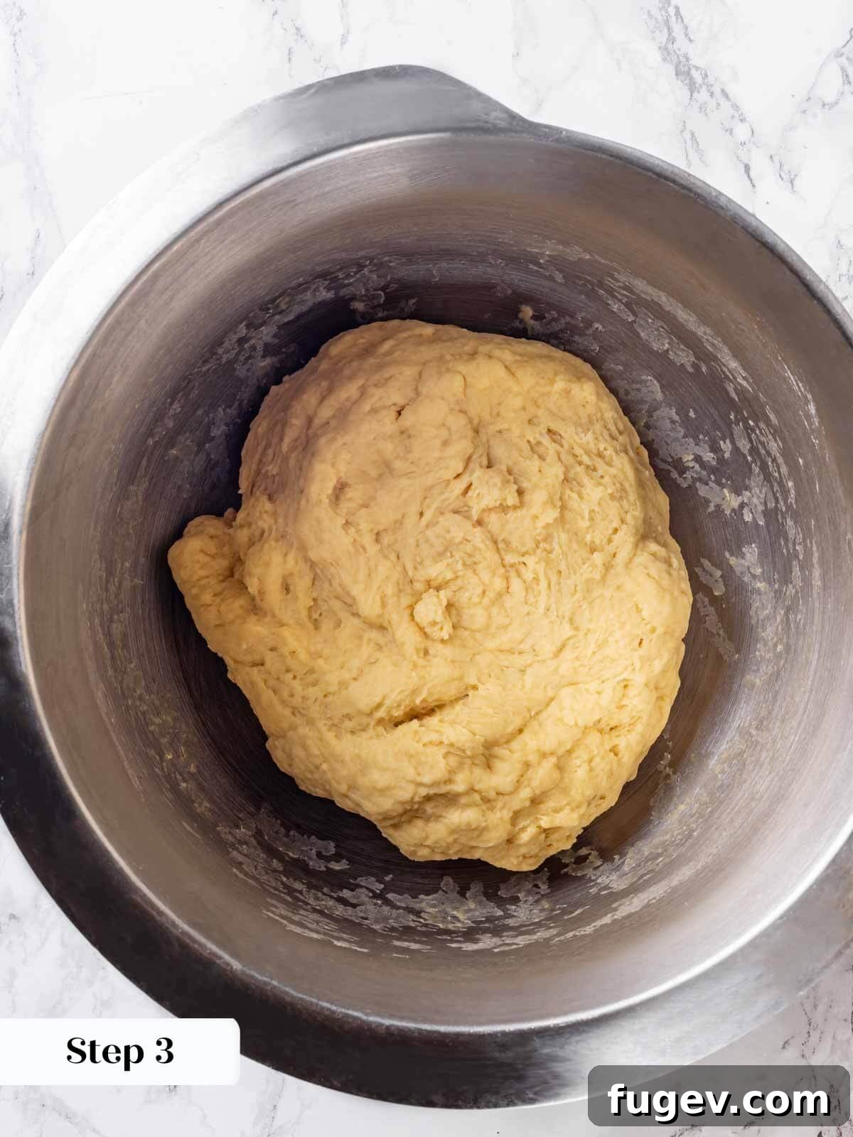 Golden Buttery Brioche Loaf 6 Brioche dough being mixed in a stand mixer, starting to come together.