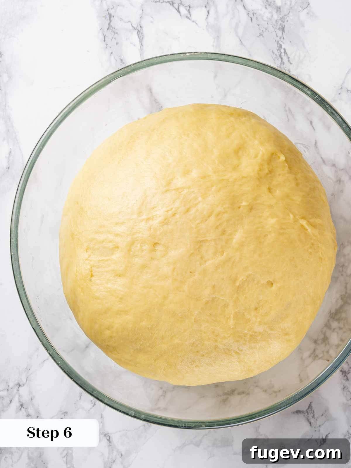 Golden Buttery Brioche Loaf 9 Brioche dough undergoing bulk proofing in a covered bowl.