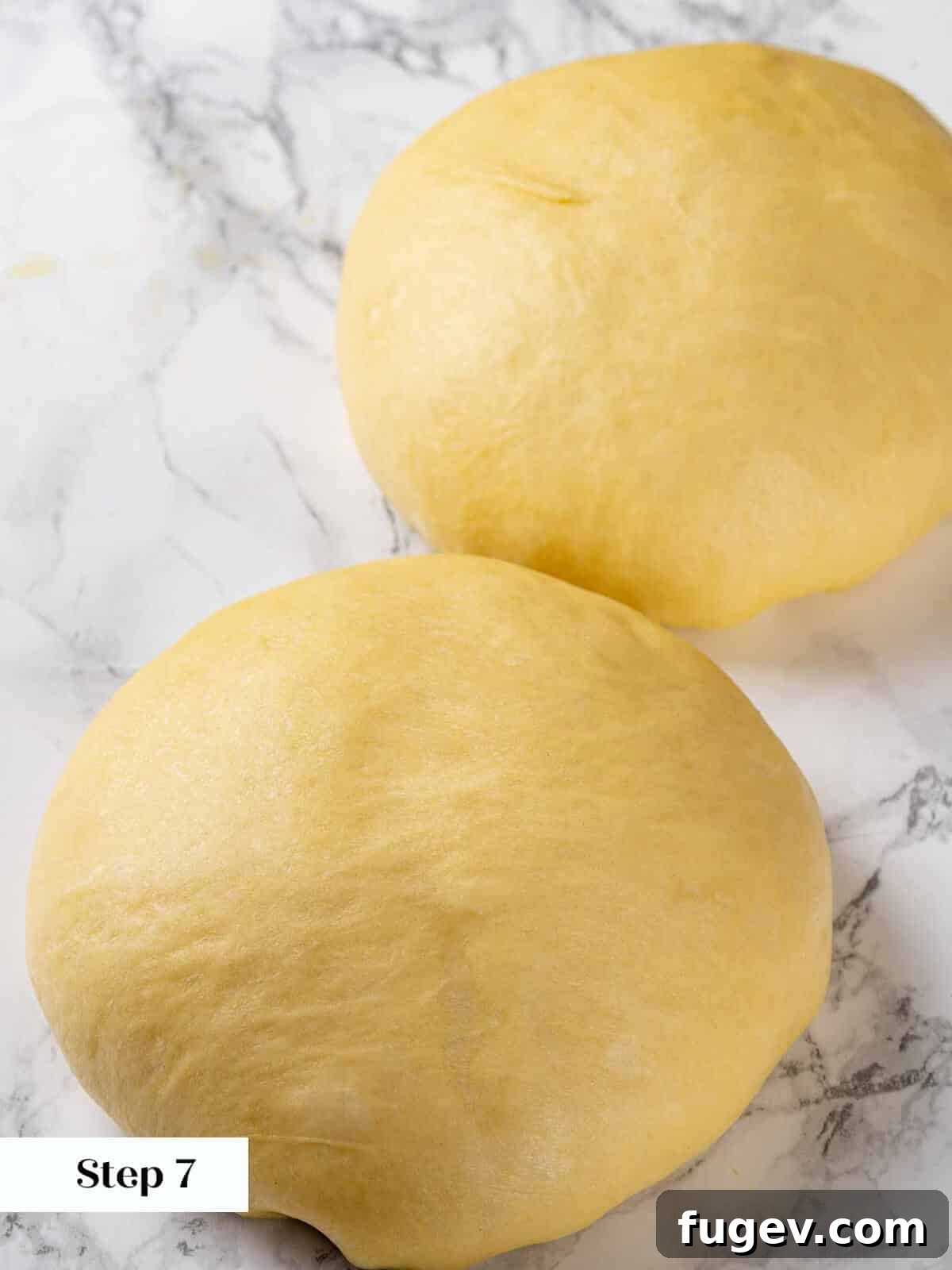Golden Buttery Brioche Loaf 10 A hand gently preshaping the brioche dough into a round.