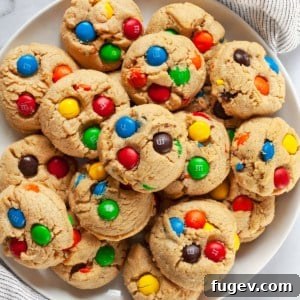 Chewy Peanut Butter Chocolate Candy Cookies 8 Delicious peanut butter cookies studded with colorful M&Ms, arranged beautifully on a plate.
