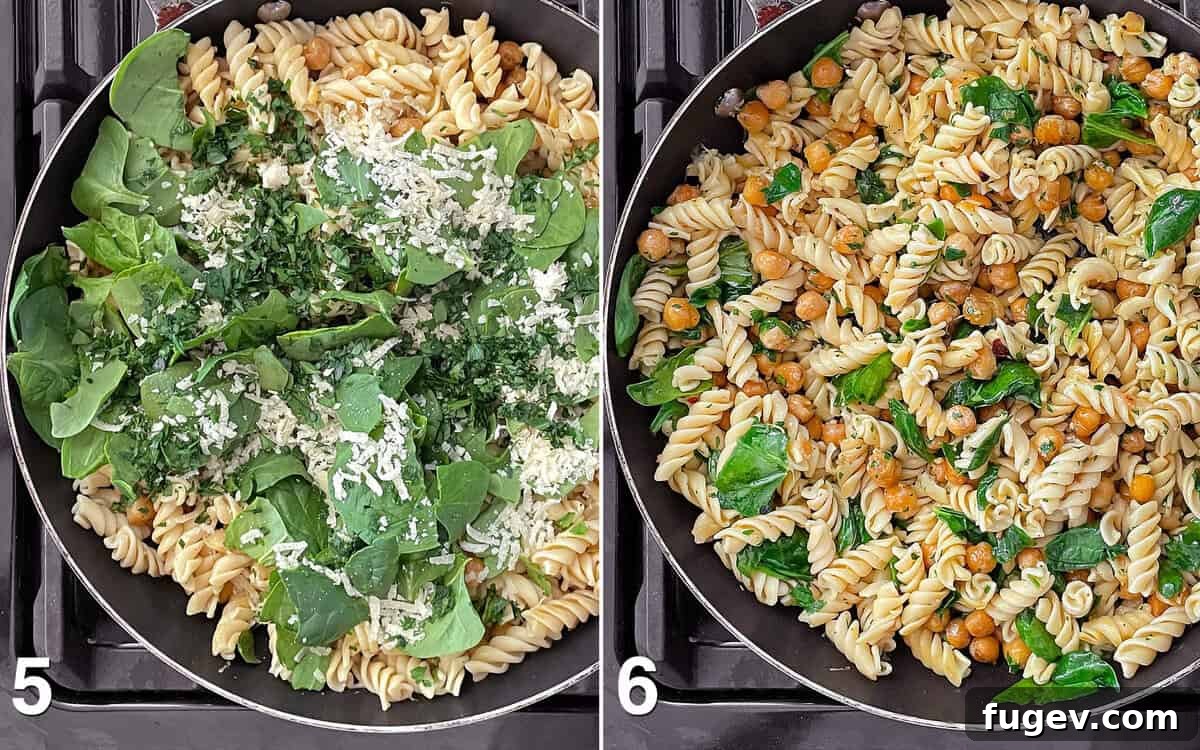 Hearty Spinach Chickpea Pasta 6 Fresh baby spinach leaves are being stirred into the chickpea pasta mixture in the skillet, starting to wilt from the heat.