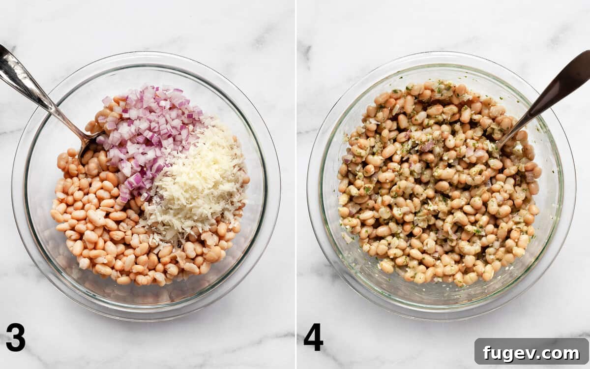 Zesty Lemon Basil White Bean Salad 5 A large bowl containing white beans, chopped red onions, and grated cheese, being gently stirred with a spoon.