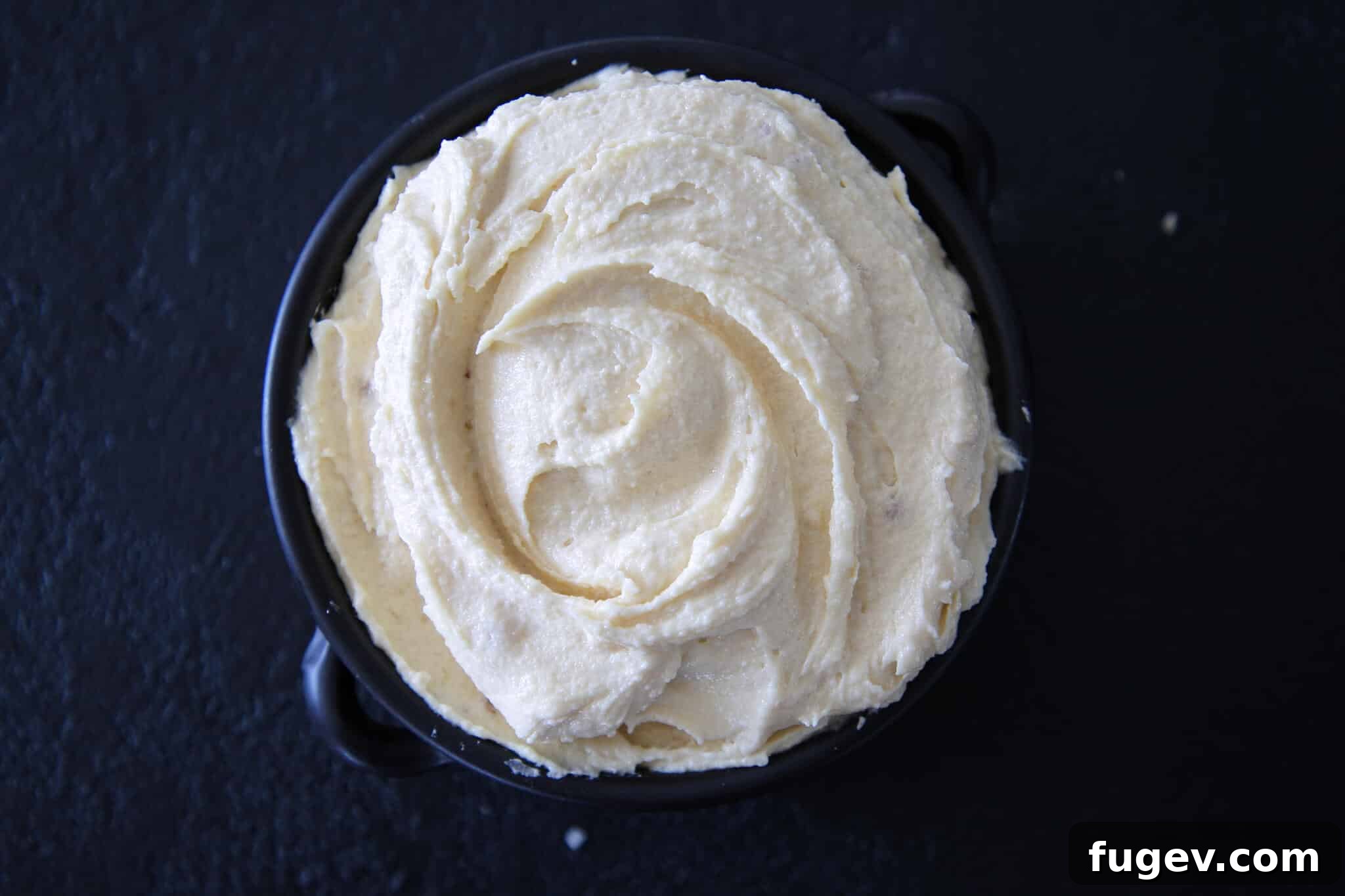 Double Almond Delight 3 Almond Cream Almond Paste in bowl on black backdrop