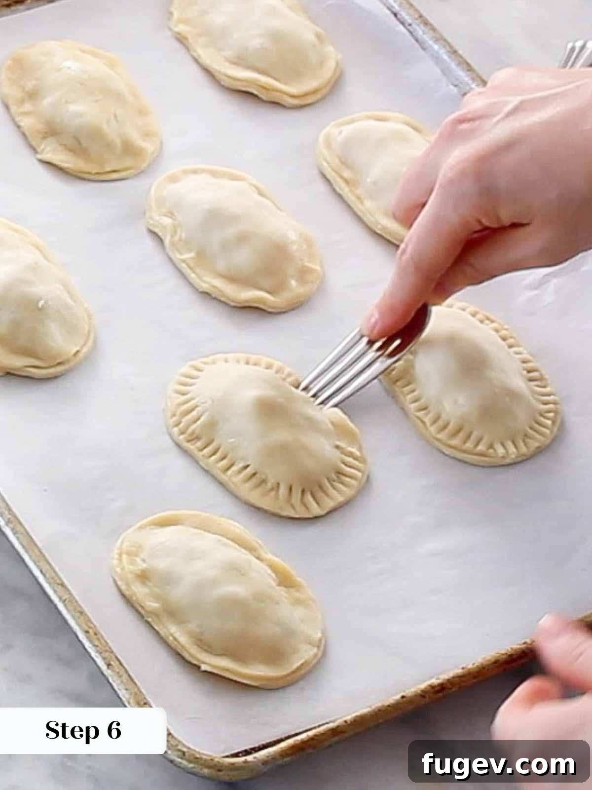Flaky Apple Turnovers 10 Sealing the edges of a hand pie with a fork, creating a decorative crimp.