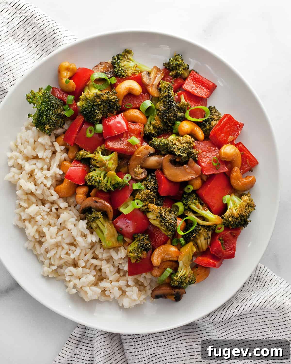 Golden Cashew Vegetable Wok 2 Veggie stir-fry with cashews and rice on a plate, ready to be enjoyed.