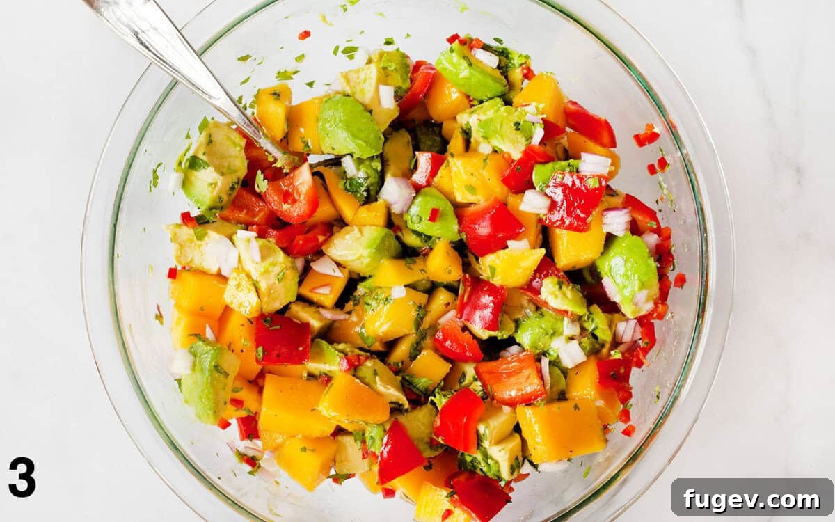 Refreshing Mango Avocado Medley 5 The fully mixed mango avocado salad, perfectly tossed with dressing, resting in a large bowl and ready to be served.
