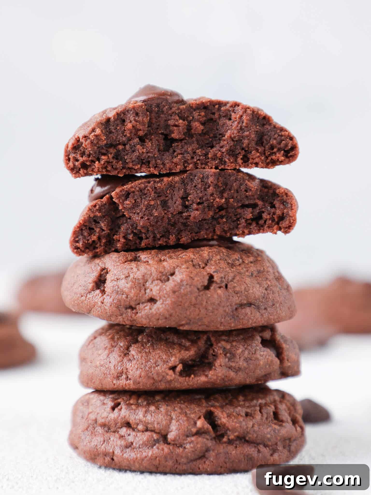 Chocolate Overload Pudding Cookies 2 Quadruple Chocolate Pudding Cookies stacked high on a white background, showcasing their thick, fudgy texture.