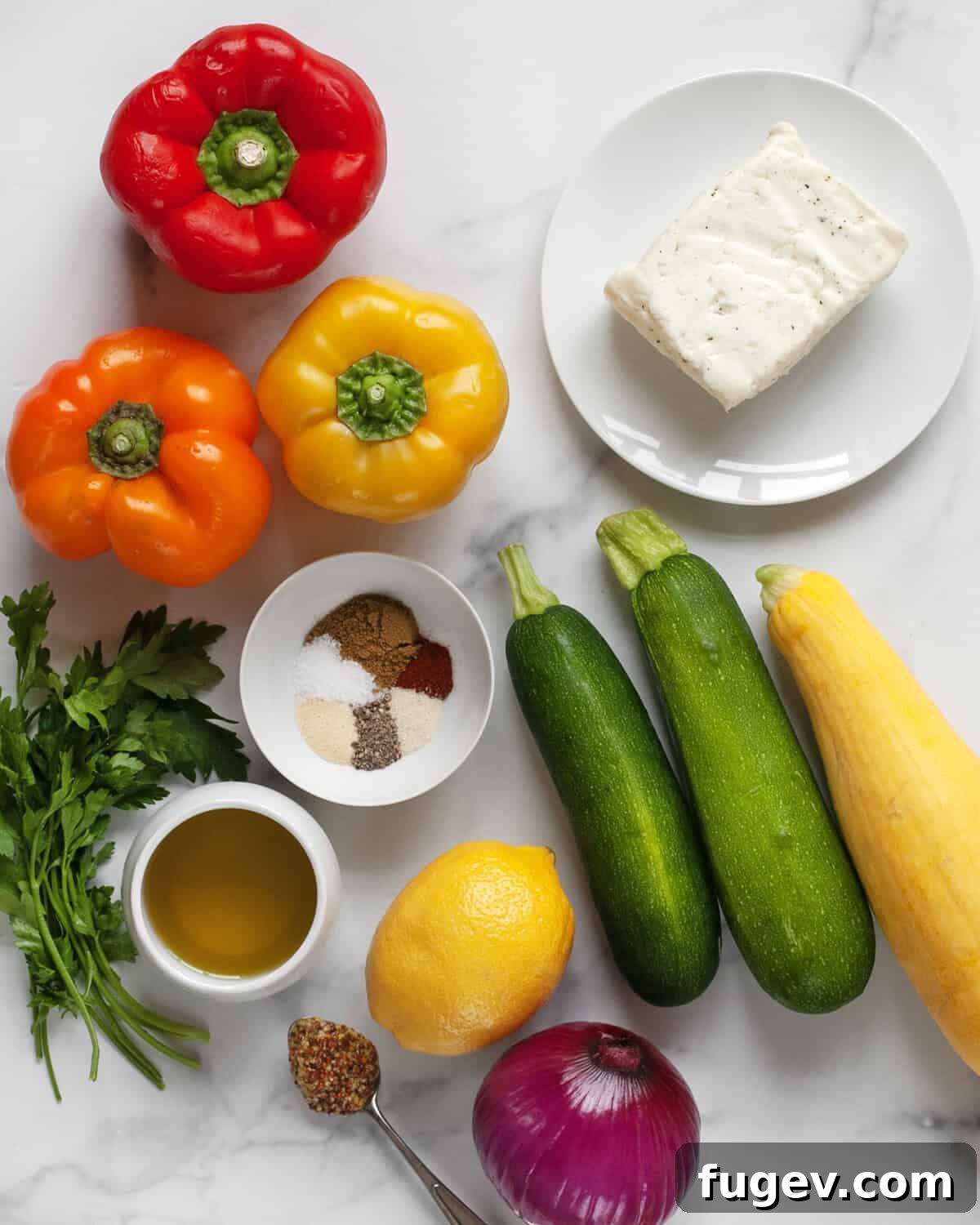 Golden Halloumi Harvest Skewers 2 Assortment of fresh ingredients for grilled halloumi and veggie skewers, including halloumi cheese, colorful bell peppers, zucchini, yellow squash, red onion, lemon, parsley, olive oil, mustard, and a selection of spices.