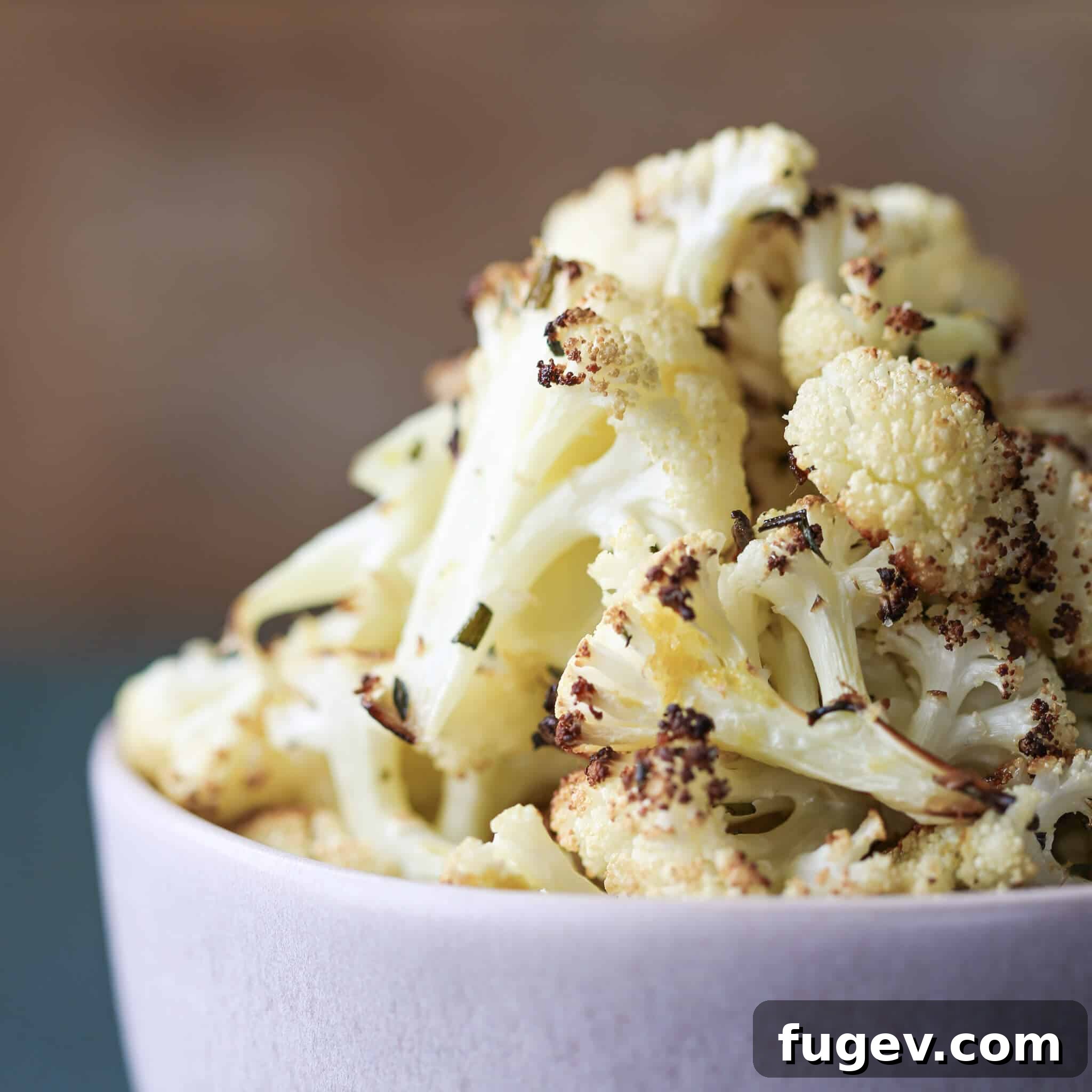 Zesty Rosemary Lemon Roasted Cauliflower 5 Easy Rosemary Lemon Roasted Cauliflower piled in bowl