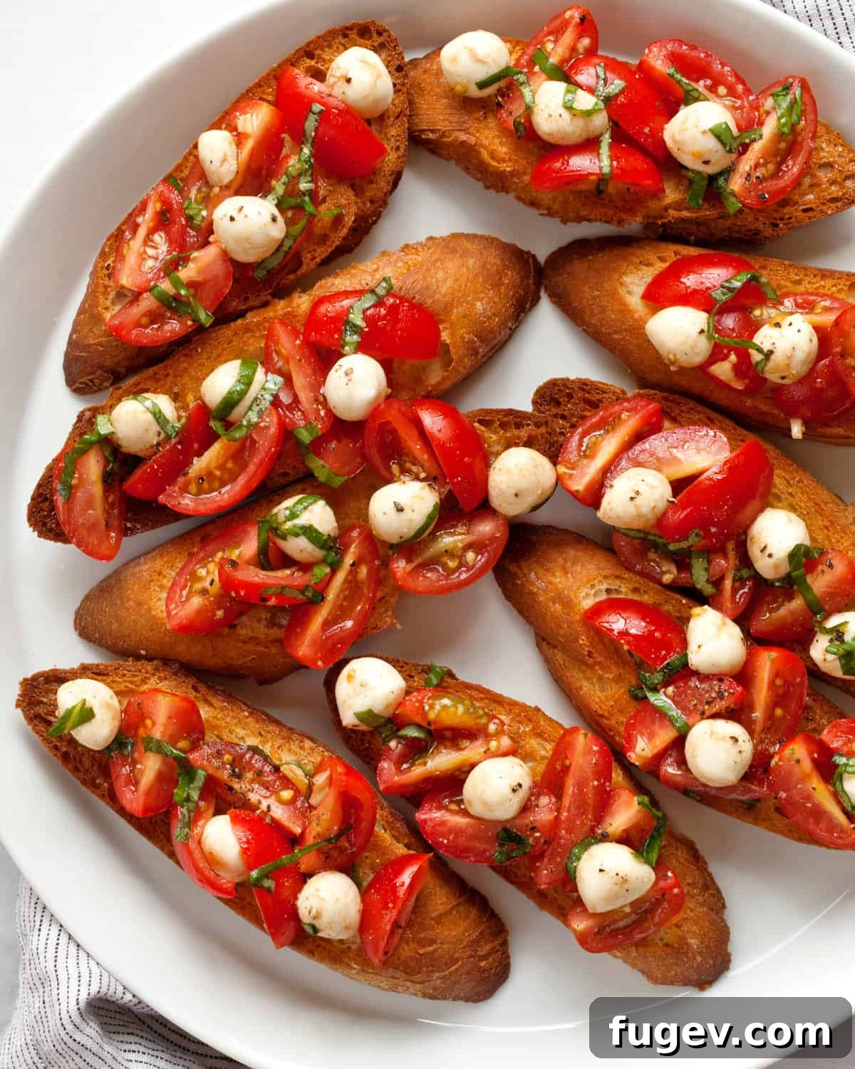 Caprese Bruschetta with Juicy Tomatoes and Creamy Mozzarella 2 A vibrant plate of Caprese bruschetta showcasing toasted bread topped with diced tomatoes, fresh mozzarella, and basil leaves.