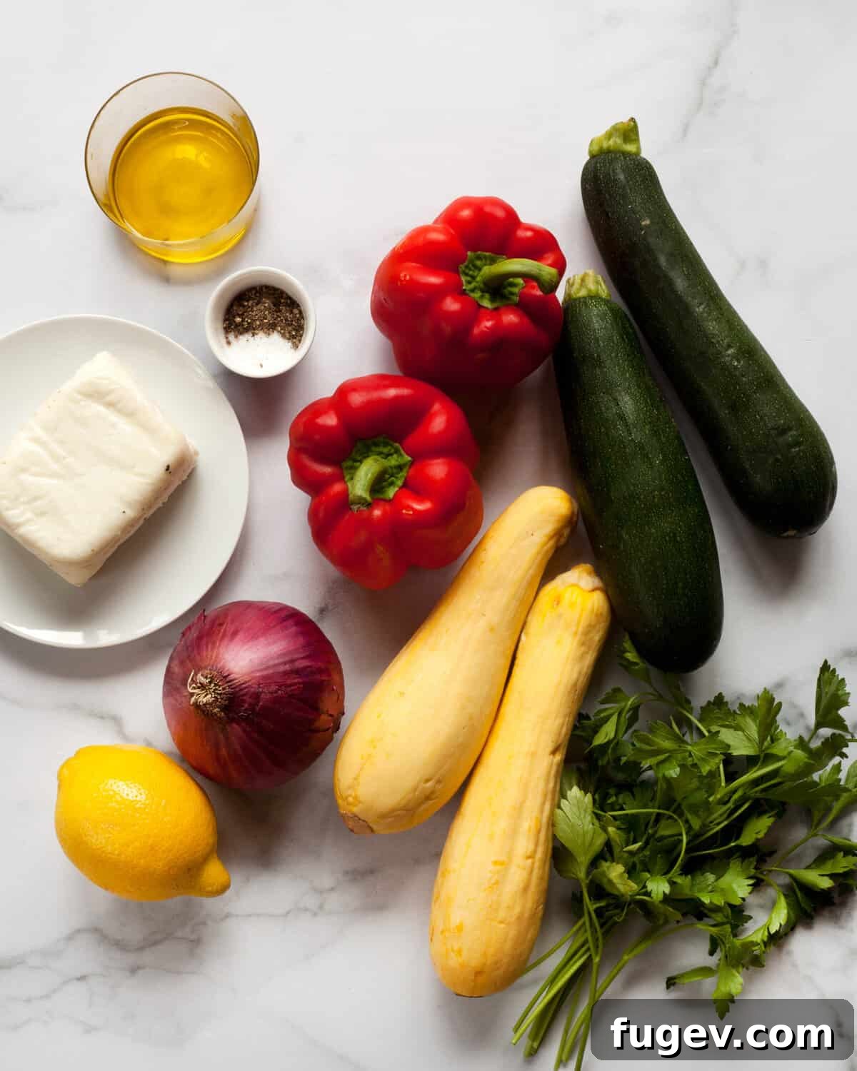 Sun-Kissed Halloumi Garden Grill 3 Fresh ingredients laid out on a cutting board including a block of halloumi cheese, sliced zucchini, yellow squash, red bell peppers, red onions, a lemon, a bottle of olive oil, and a small bowl of salt and pepper.